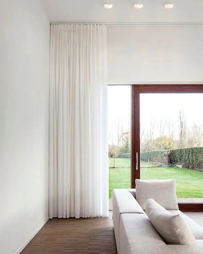 ceiling mounted living room curtains creating luxury look